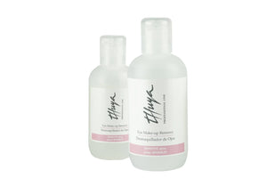 Two transparent bottles of Thuya Eye Make-up Remover for sensitive skin with flip-top caps and soft pink label detailing.