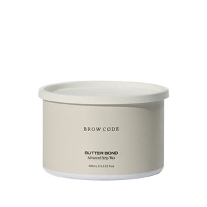 Brow Code Butter Bond Advanced Strip Wax in a 400mL beige tub with white lid, formulated for gentle yet effective eyebrow and facial hair removal
