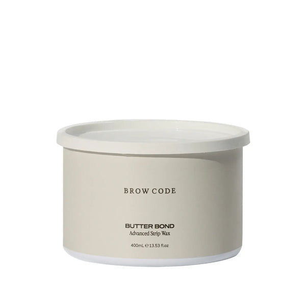 Brow Code Butter Bond Advanced Strip Wax in a 400mL beige tub with white lid, formulated for gentle yet effective eyebrow and facial hair removal