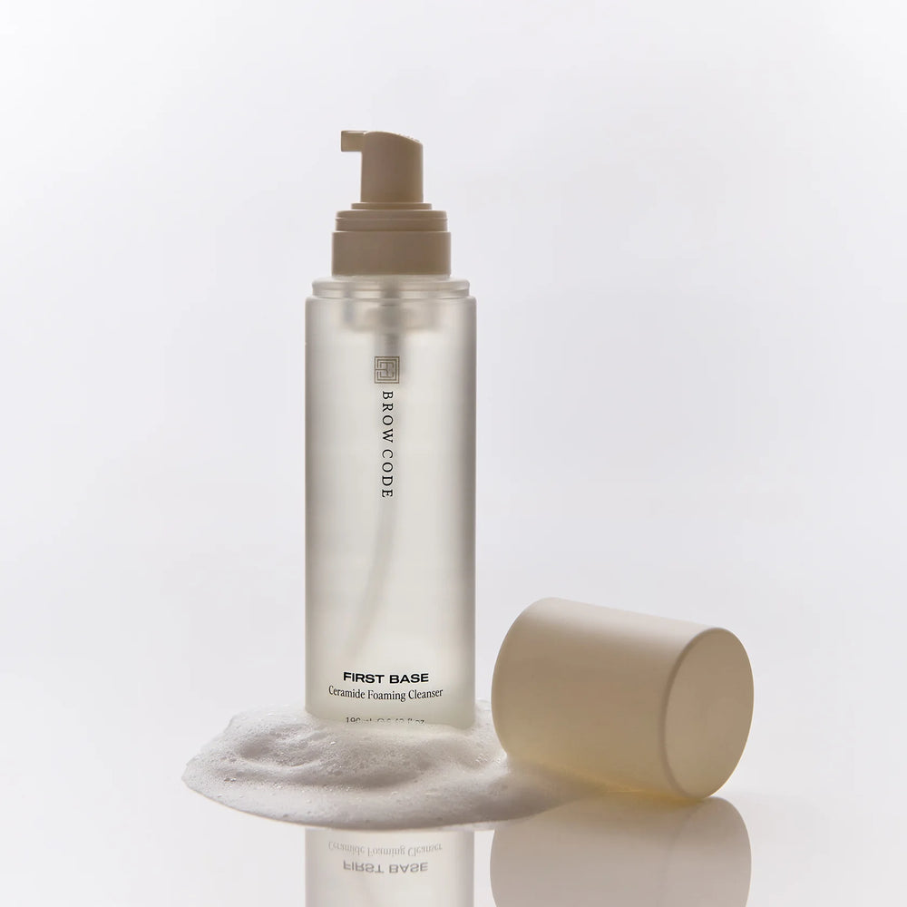 Brow Code First Base Ceramide Foaming Cleanser in a sleek, frosted 190ml bottle with minimalist black text and a matte cream pump cap