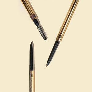 Brow Code Imitations Micro Brow Pencil in gold, featuring an ultra-fine tip for precise strokes and a spoolie brush for blending natural-looking brows