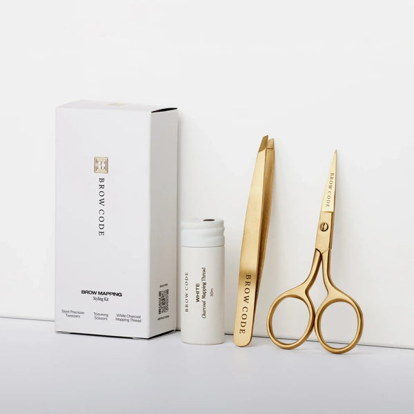 Brow Code Mapping Kit with slant tweezers, trimming scissors, and white charcoal thread for precise brow shaping and symmetrical mapping