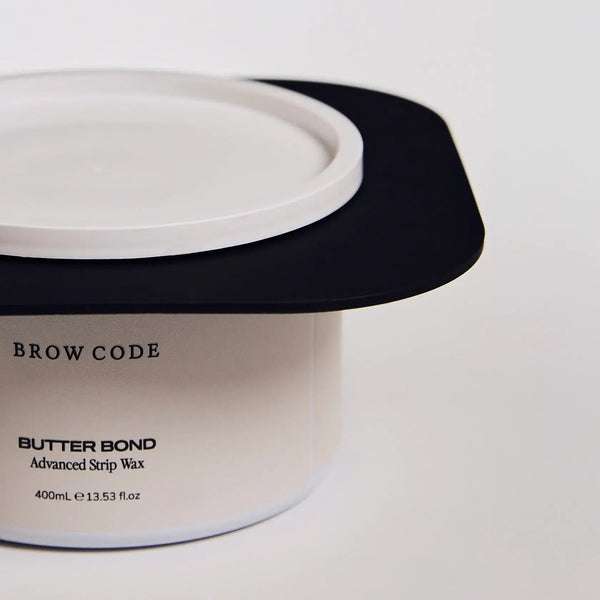 Brow Code silicone wax collar fitted on a Butter Bond Advanced Strip Wax 400ml container for a mess-free waxing experience