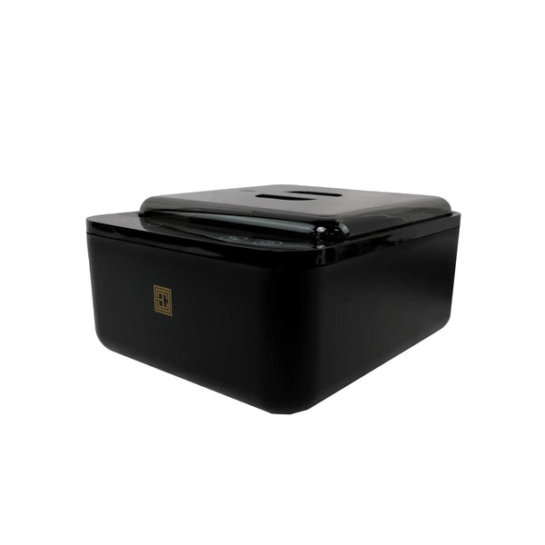 Angled view of Brow Code black wax warmer featuring sleek design with gold logo and digital temperature control panel under lid
