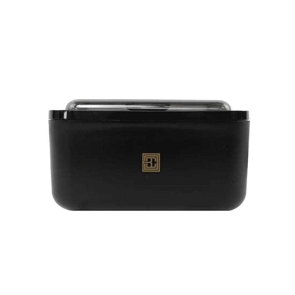 Brow Code wax warmer in sleek black design with a transparent lid and gold logo, ideal for professional eyebrow waxing treatments