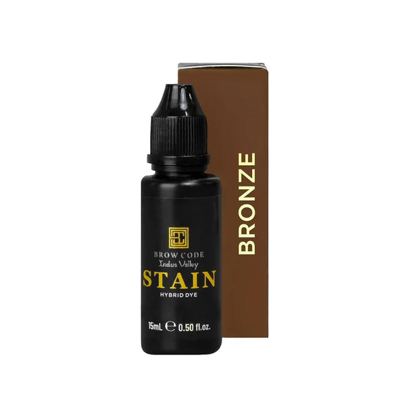 Brow Code Stain Hybrid Dye in Bronze shade, featuring a 15ml matte black bottle with a warm golden-brown box for professional brow tinting