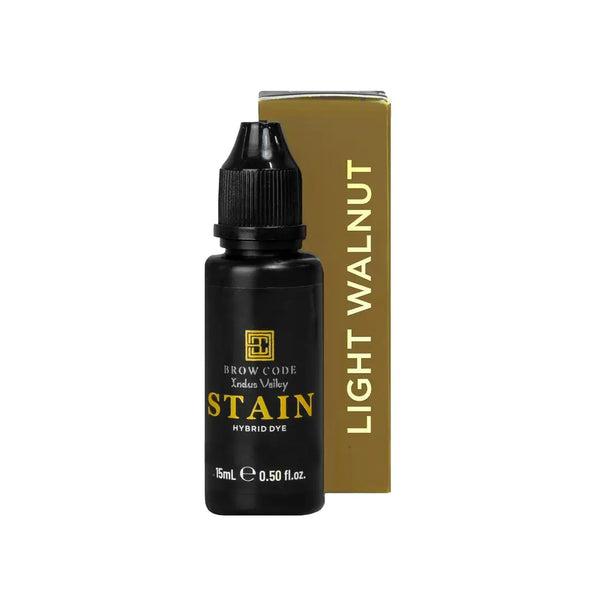 Brow Code Stain Hybrid Dye in Light Walnut shade, featuring a 15ml black bottle and matching gold box for professional eyebrow tinting