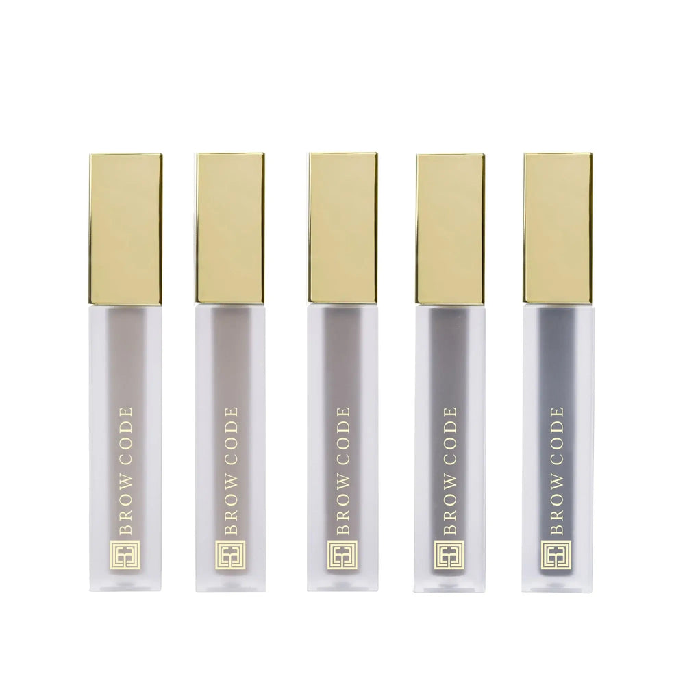 Brow Code Tinted Multi-Peptide Brow Gels in sleek frosted tubes with gold caps, showcasing five shades designed to tint, define, and nourish brows