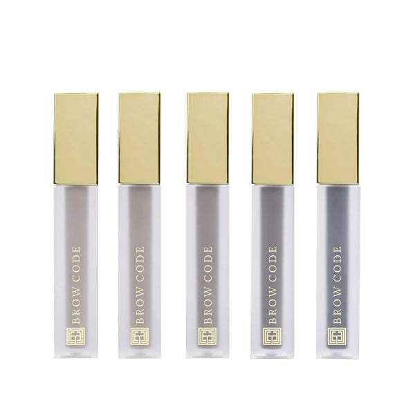 Brow Code Tinted Multi-Peptide Brow Gels in sleek frosted tubes with gold caps, showcasing five shades designed to tint, define, and nourish brows