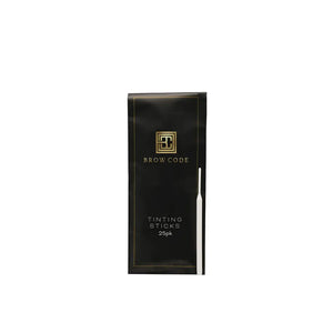 Brow Code Tinting Sticks 25-pack in a sleek black and gold pouch with one white tinting stick placed alongside the packaging
