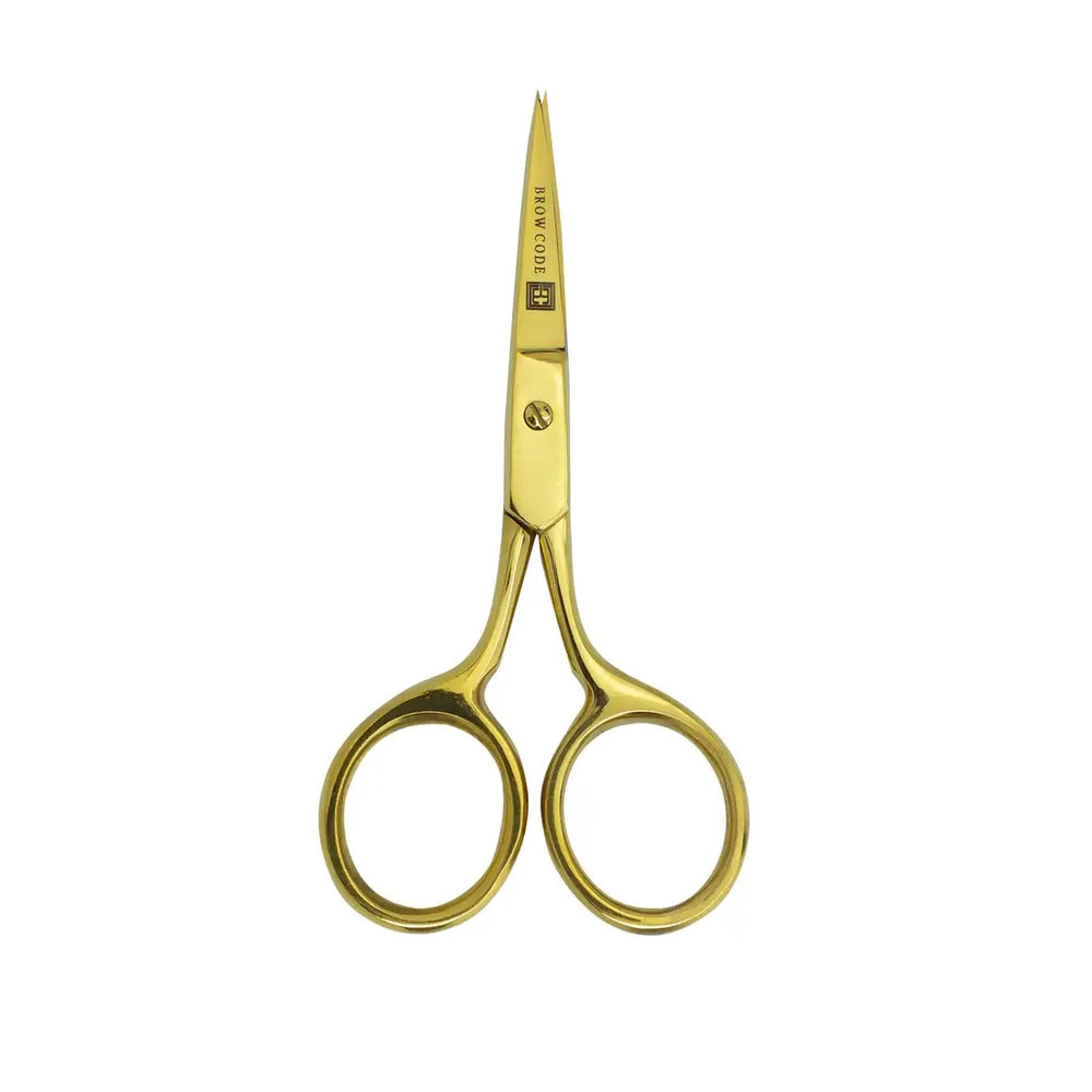 Brow Code gold precision trimming scissors with sharp pointed blades, designed for detailed eyebrow grooming and shaping