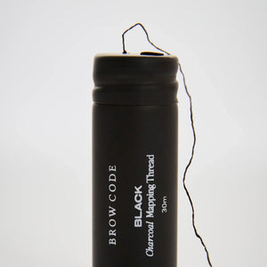 Brow Code Black Charcoal Mapping Thread 30m with visible thread emerging from spool, ideal for precise brow shaping and mapping accuracy