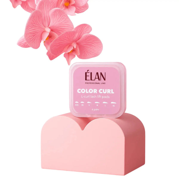 Élan Color Curl L-Curl Lash Lift Pads in pink box displayed on a pastel pedestal with pink orchids, showcasing six pairs of silicone shields for creating lifted L-curl lash effects