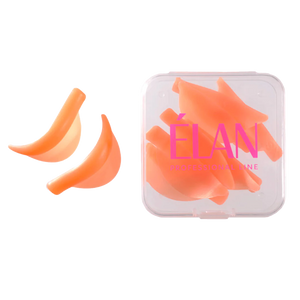 Soft orange ÉLAN lash lift shields shown with two samples and a full set inside a transparent case, ideal for creating precise lash curls during lamination
