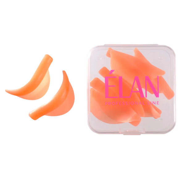 Soft orange ÉLAN lash lift shields shown with two samples and a full set inside a transparent case, ideal for creating precise lash curls during lamination