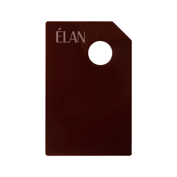 Élan Dye mixing palette in a sleek dark brown finish with a corner hole for grip, designed for blending eyebrow and eyelash tints with precision.