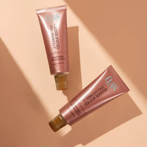 Two pink tubes of Elan eyebrow tint on a beige background