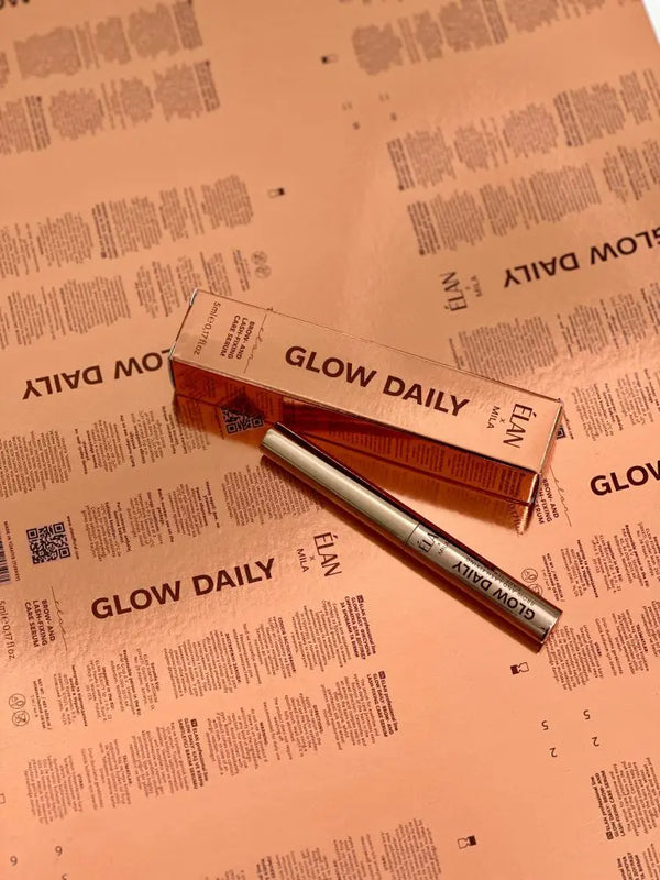 Élan x Mila Glow Daily Brow and Lash Fixing Serum with its rose gold packaging, displayed on branded insert sheets for a stylish look