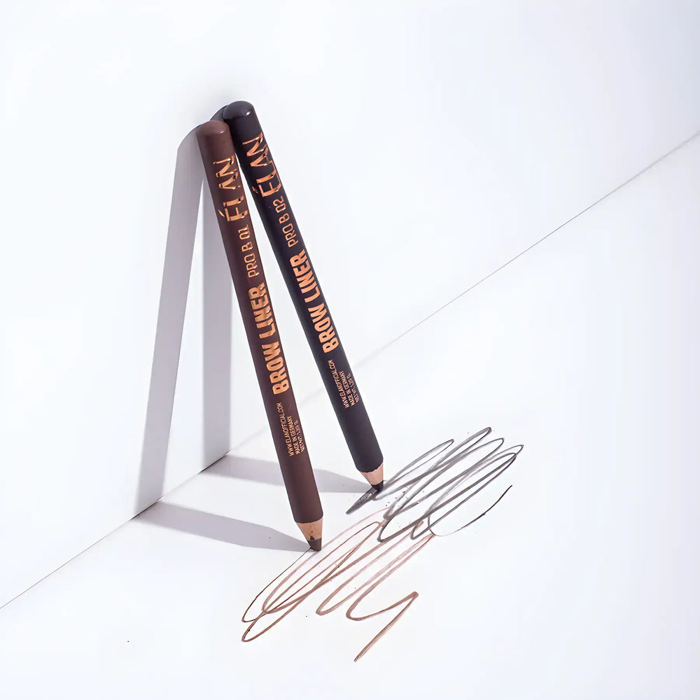 Two ÉLAN Brow Liner Pro pencils in shades B01 and B02 shown drawing smooth, powder-finish brow strokes on a white surface.