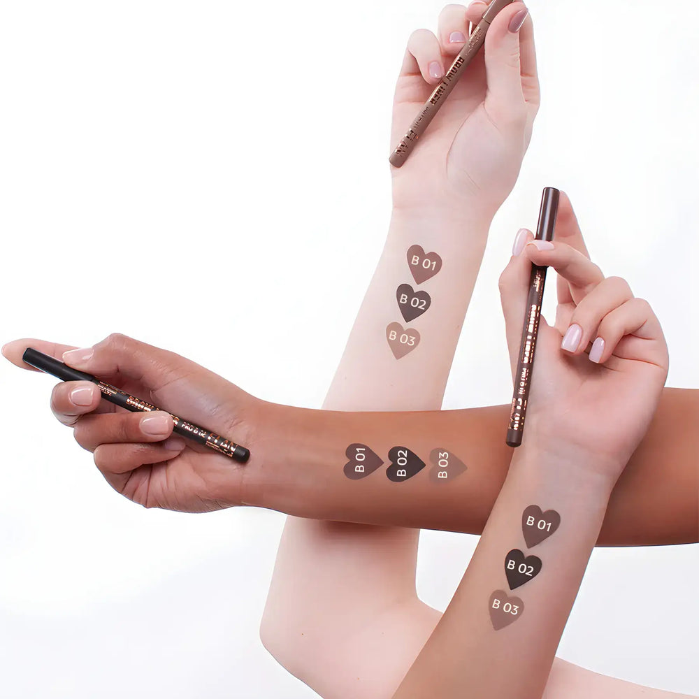 Two ÉLAN Brow Liner Pro pencils in shades B01 and B02 shown drawing smooth, powder-finish brow strokes on a white surface.