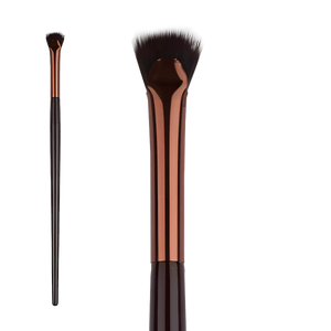 Élan Professional Brush Face No.27 featuring a unique curved synthetic bristle head and copper ferrule for sculpting and defining facial contours with precision